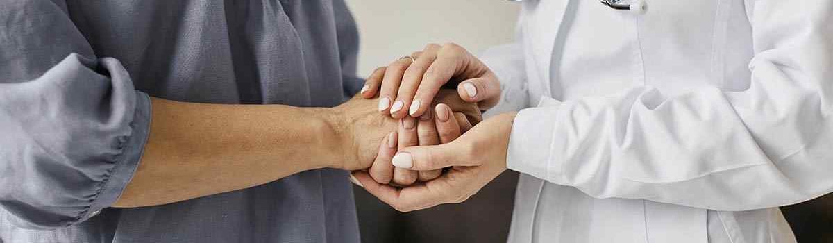 covid-recovery-center-female-doctor-holding-older-patient-s-hands